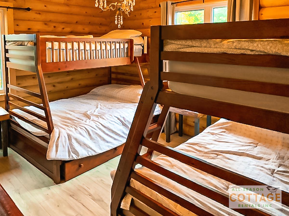 Bedroom #1 is located on the main floor (off dining room) with two sets of Single/Double bunk beds.